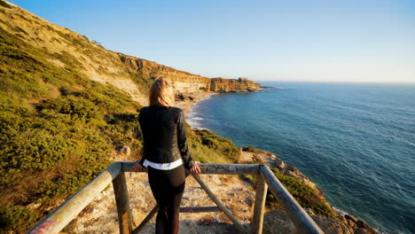 a girl is walking to the beach of lisboa, portugal