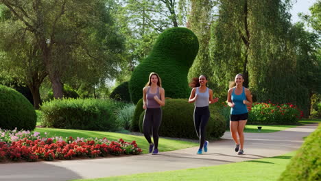three women jogging in a park