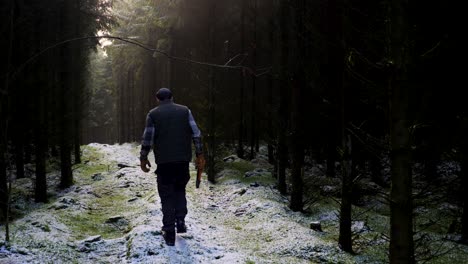 Man-walking-into-forest,-static-shot