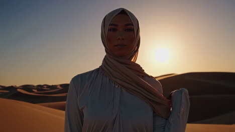 woman in hijab at sunset in the desert