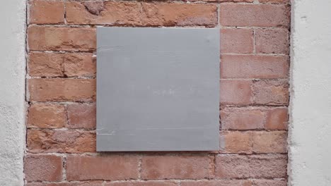 blank sign on a brick wall