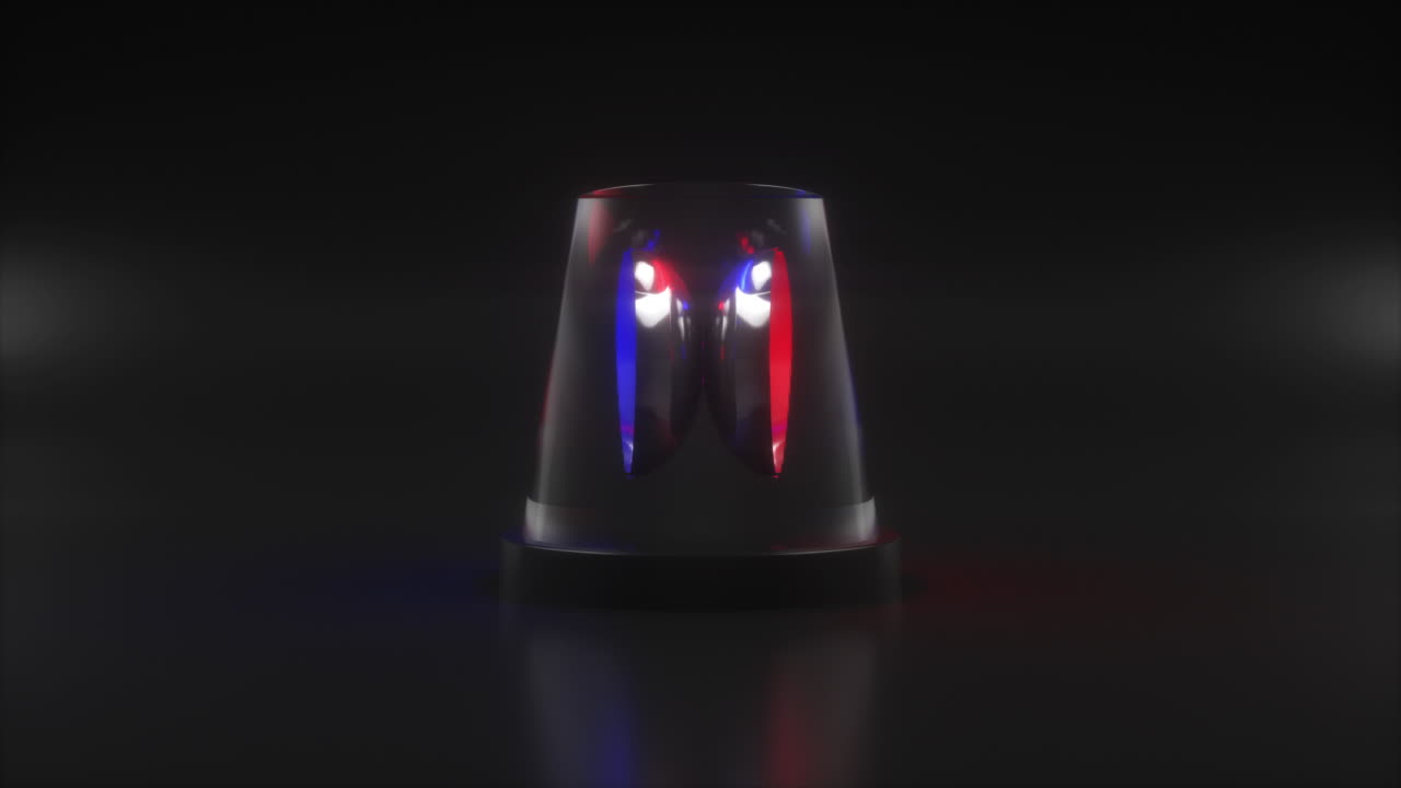 Flashing warning siren light rotates and changes colors from blue to red on black background