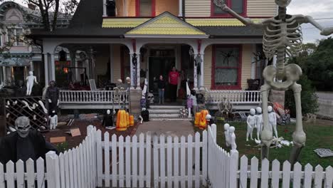 family posing in front of their spooktacular halloween house