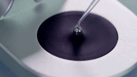 scientists or technicians loading a sample to centrifuge machine to analyzing. advanced research lab with modern equipment. drug or vaccine development in professional biotechnology laboratory
