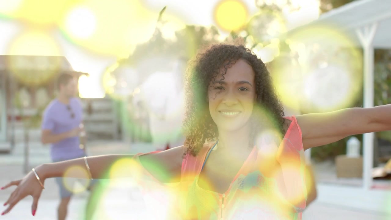 Camera pushing in, woman in coverup fixing hair, dancing, bokeh masking then clearing for marketing