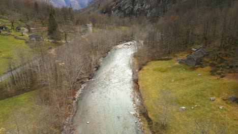 approaching aerial drone shot of a village in cavergno and the river maggia, situated in the district of vallemaggia, a canton of ticino in switzerland