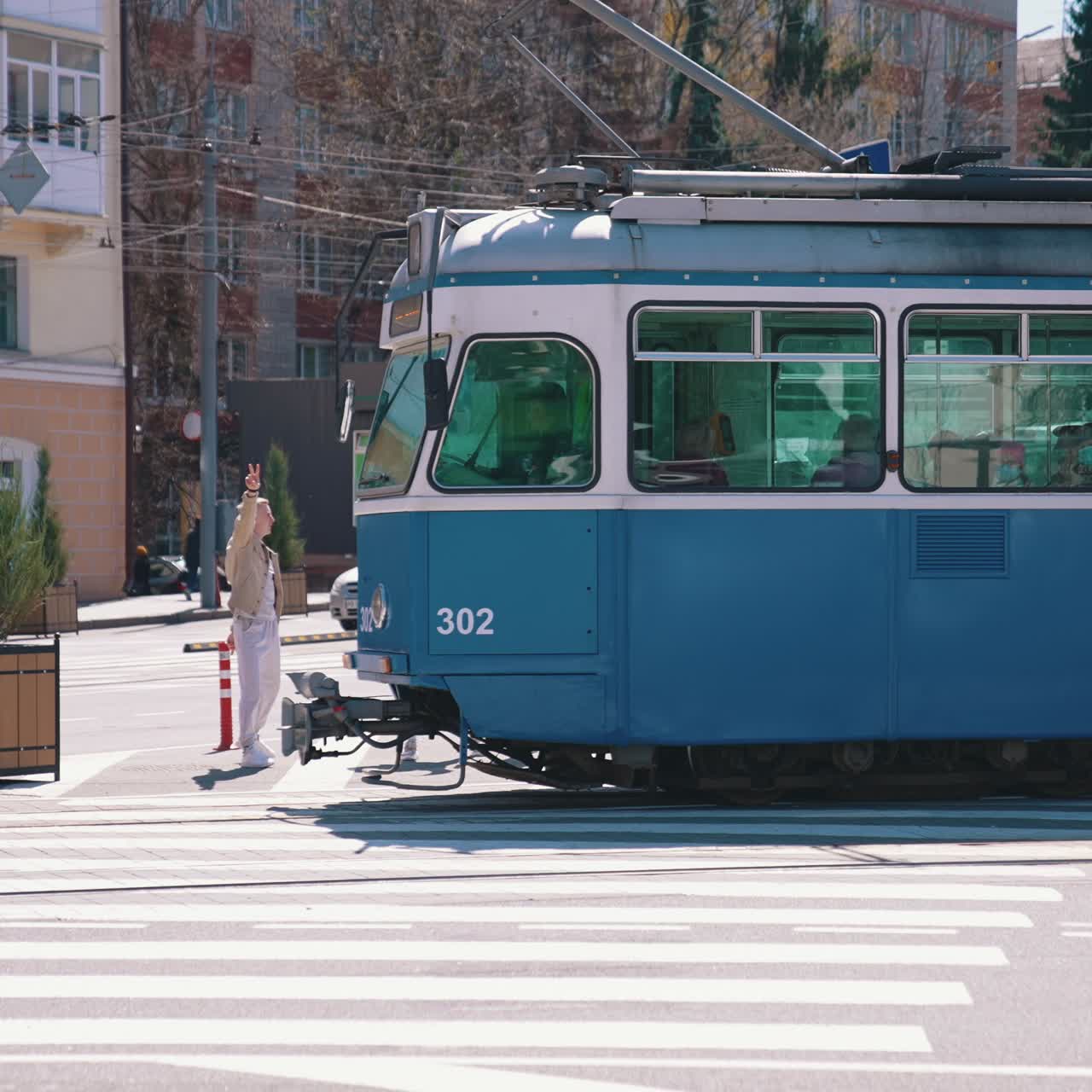Happy friends dancing at the road. Group of young people having fun outdoors. Guys enjoy their life together concept