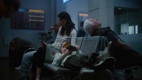 tired travelers in airport waiting area