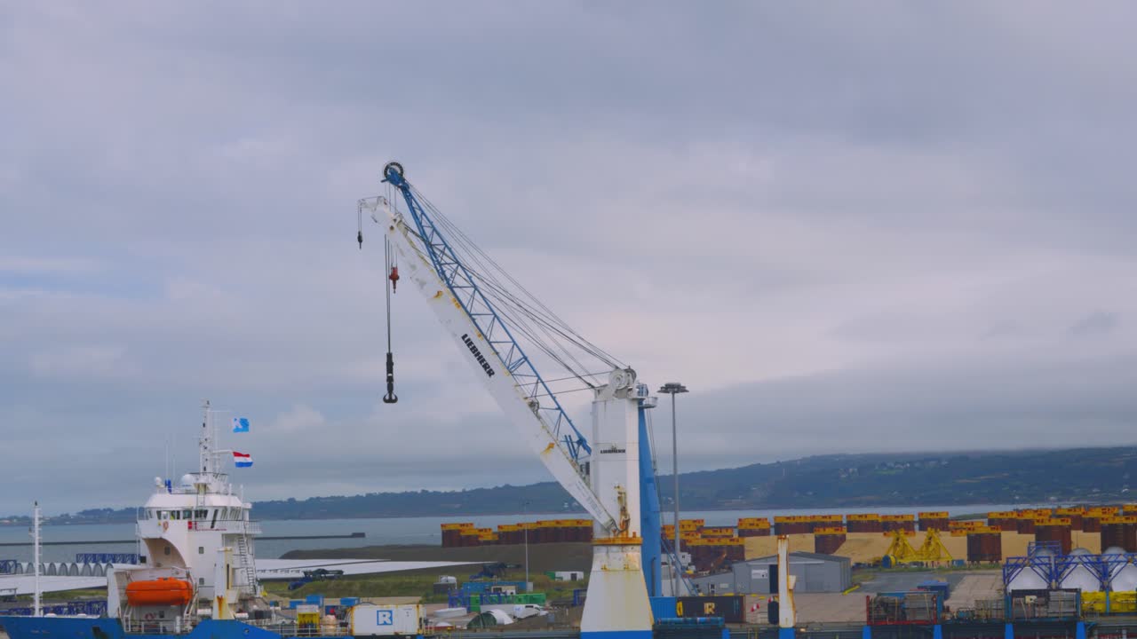 Crane in Cherbourg Harbour Port Next to Ship Docked Being Loaded Ready to Transport Cargo 4K