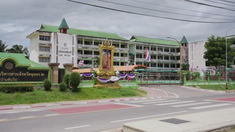 wide view of a thai rural school with the king and queen portrait in thailand