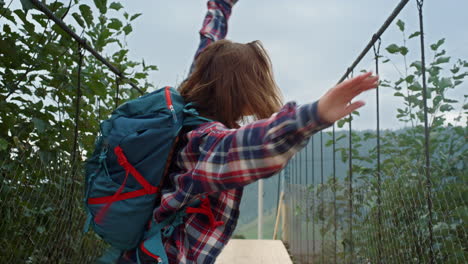 euphoric girl hike jump at mountains nature. happy woman express emotion outside