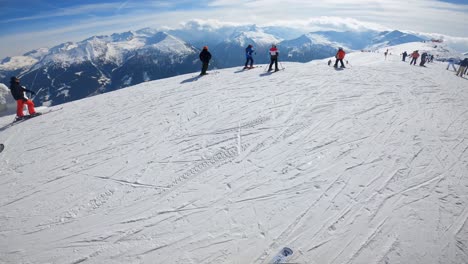 POV-skier-putting-on-the-skis-on-top-of-a-mountain