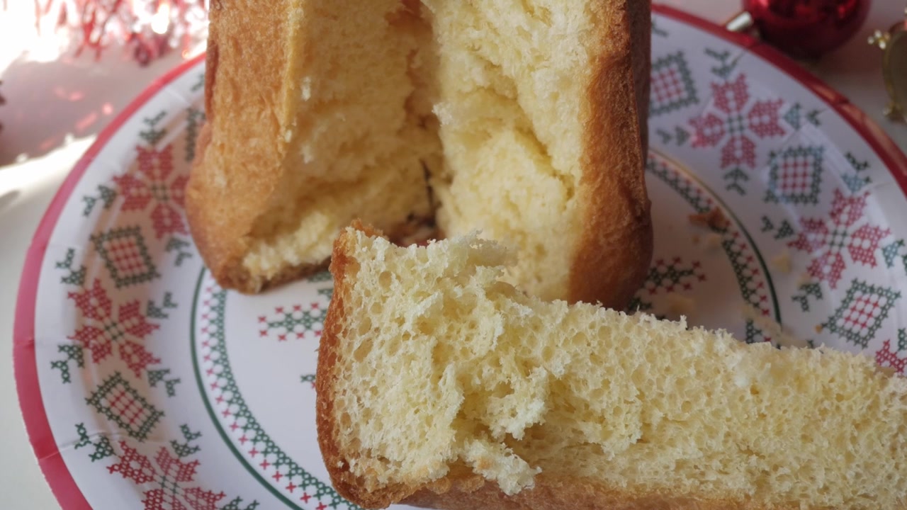 Panettone on decorative plate, cozy Christmas festive mood, warm family gathering