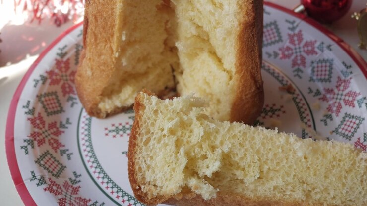Panettone on decorative plate, cozy Christmas festive mood, warm family gathering