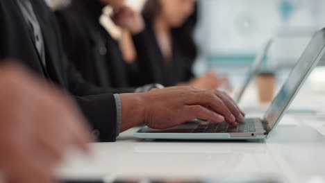 Hands-of-man-at-meeting-in-office-with-laptop