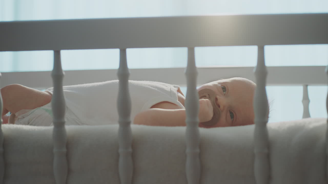 Baby in crib with pacifier