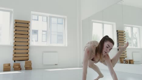 woman doing yoga and dance poses in a studio