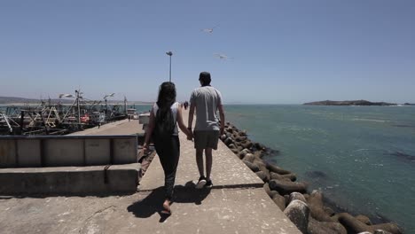 a young couple walking in the essaouira port