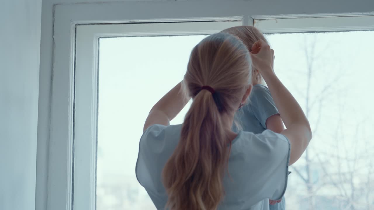 Mother putting mask on her daughter
