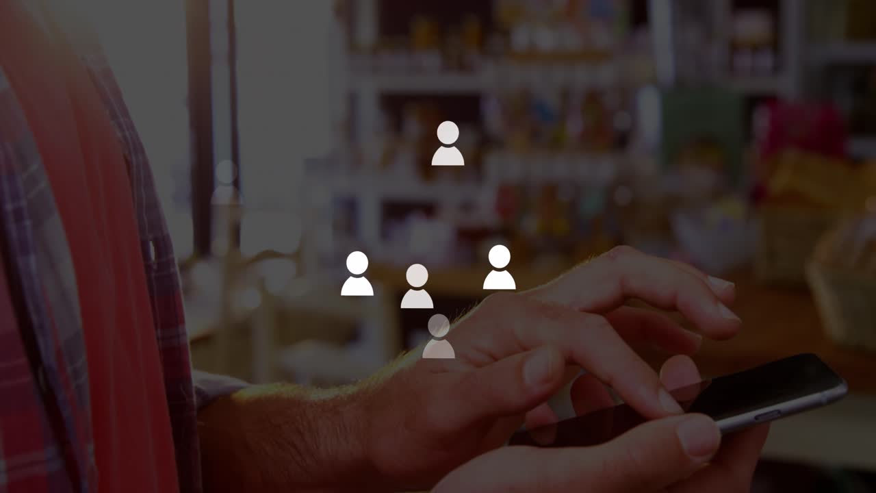 Animation of icons over hands of caucasisn man using smartphone