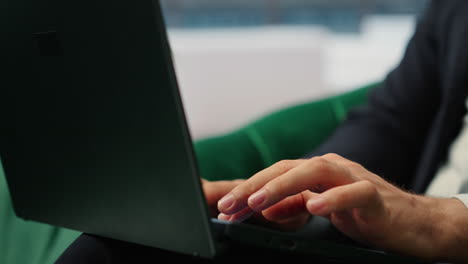 vertical video close up of businessman typing information for daily tasks on laptop