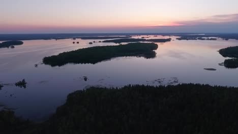 Aerial-of-a-lake-and-forest-at-dawn-in-Finland