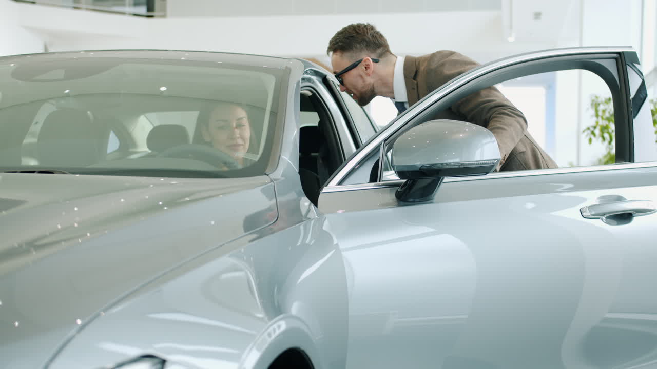 Customer and Salesperson in Car Showroom