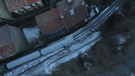 Aerial-Drone-Fly-Above-The-Vall-de-Nuria-Rack-Railway-Train-in-Winter,-Snow-at-Ribes-de-Freser,-Catalonia,-Pyrenees