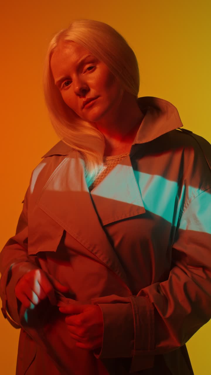 Fashionable Woman in Trench Coat with Dramatic Lighting