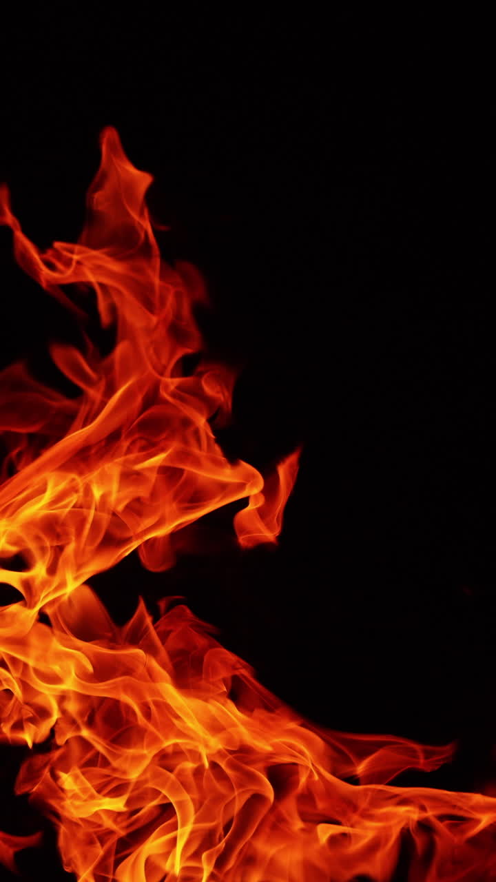 Upper part of bonfire burning at night. Flame tongues reach into the air