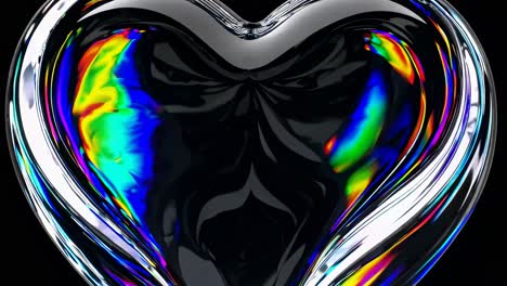 close-up video of a glass heart with rainbow reflections. captured from a front angle