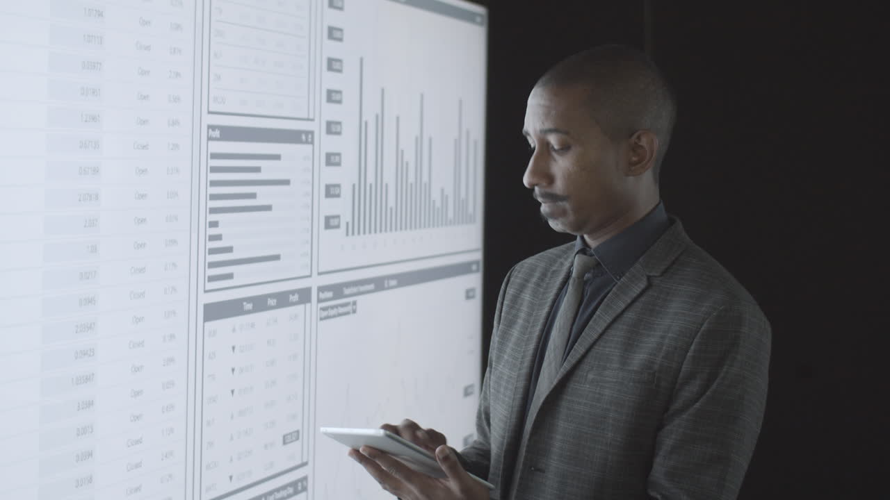 Focused black finance professional analyzing charts