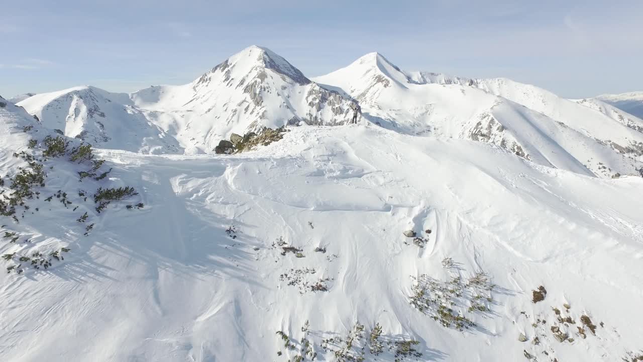 Adventurous Climber on Snowy Mountain Peak