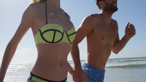 romantic couple running together at beach 4k