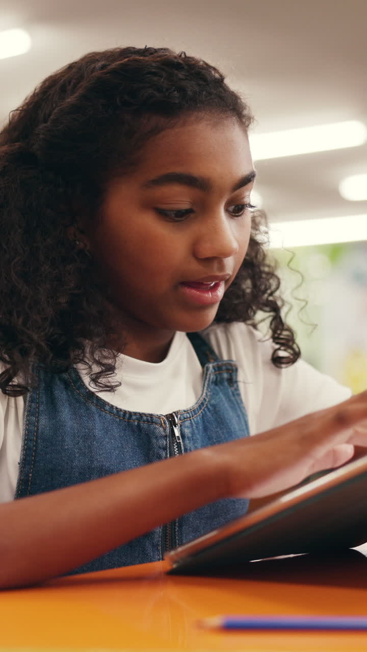Young Girl Focused on Digital Tablet for Learning