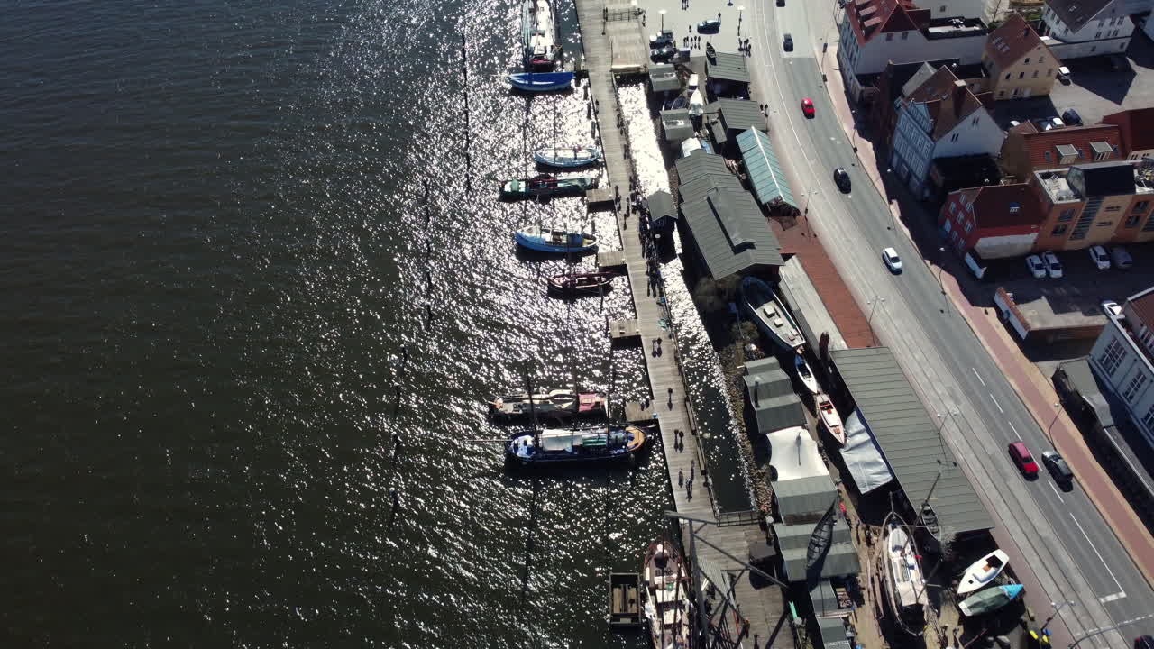 Aerial view of a European harbor with boats and city