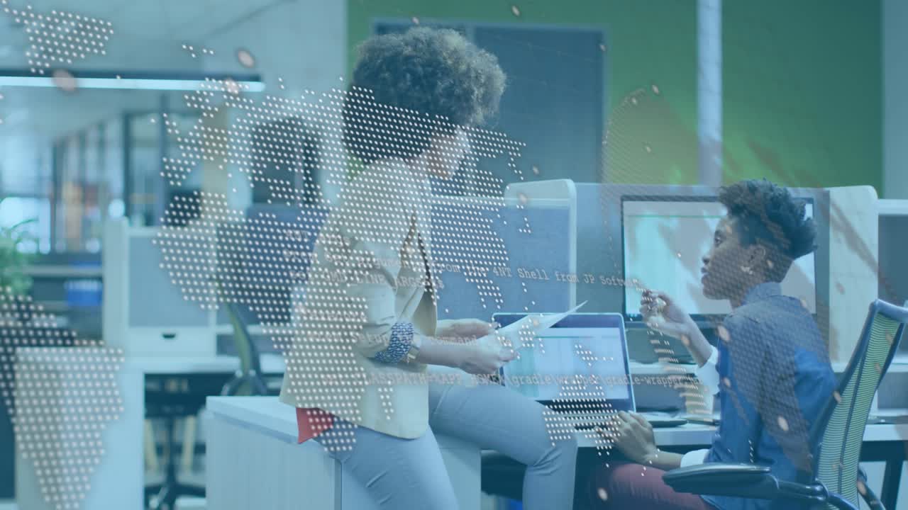 Walking woman perching on desk, pointing at laptop, peer typing, map or code overlaying reviewing te