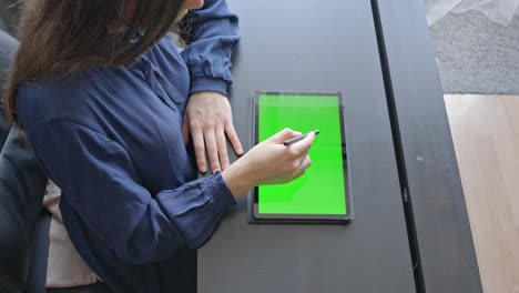 Elegant-woman-working-with-tablet-computer-on-table,-top-down-view