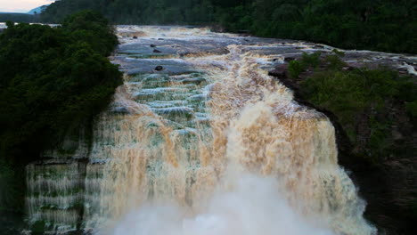 powerful waterfall cascading through lush green landscape
