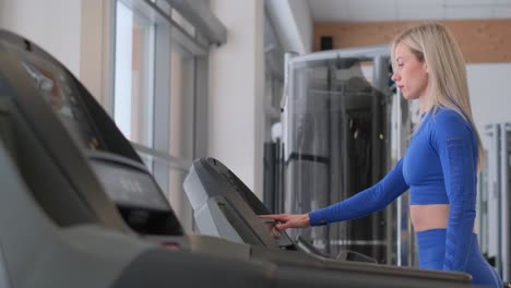 woman using a treadmill in a gym