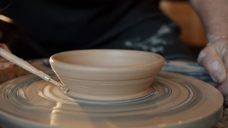 creating a bowl on a pottery wheel