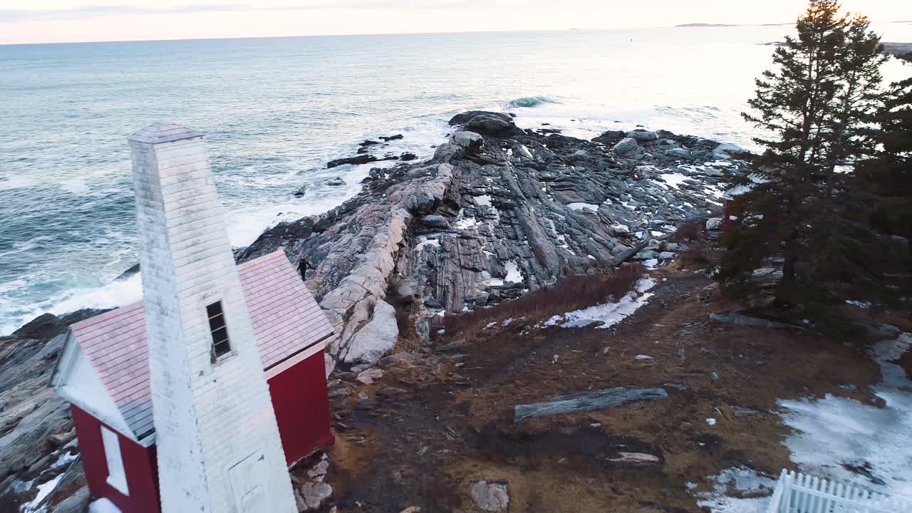 Turisti kävelemässä Grindel Pointin majakan kalliorannalla Islesborossa, Mainessa, Yhdysvalloissa