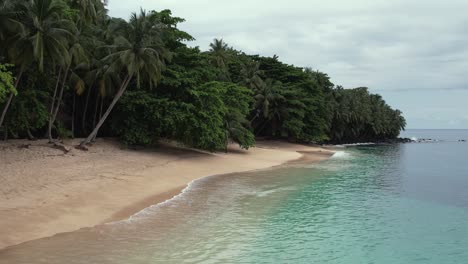 Drone-flyover-secluded-tropical-Banana-beach-in-Principe-Island,-São-Tomé-e-Principe