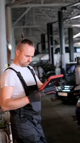 mechanic using diagnostic tool in auto repair shop