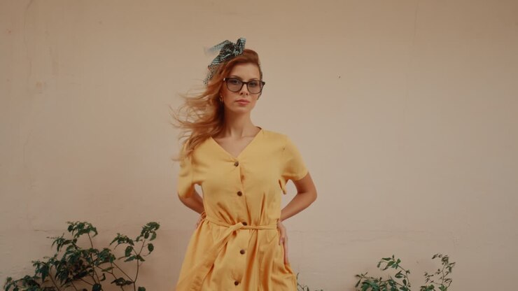 Woman in Yellow Dress and Glasses Posing Outdoors