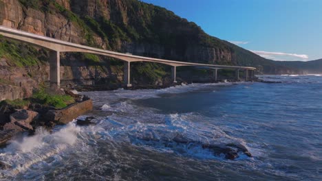 sunrise sea cliff bridge costal drone view iconic famous stanwell park waves ocean crashing south coast nsw australia landscape royal national park wollongong coalcliff iiawarra sydney static