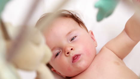 Cute-baby-playing-with-mobile-in-his-crib