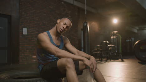 an athletic african american man in the gym.