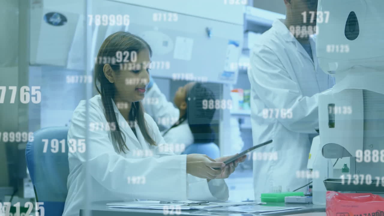 In laboratory, scientists in lab coats analyzing digital data with animation overlay