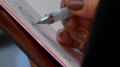 An artist sketching a building out doors closer shot